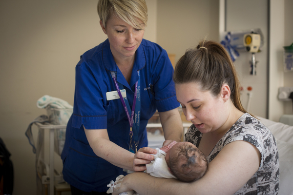 Mother, baby and midwife in UK. 