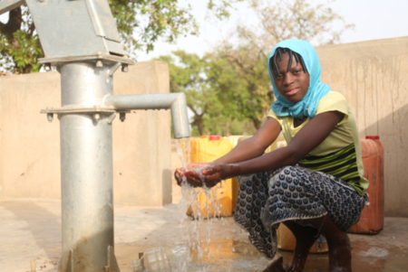 Nassiratou collecting water at the new borehole constructed in the district of Samb Naaba, in the village of Loukou, commune of Tenkodogo, Centre-East region, Burkina Faso.