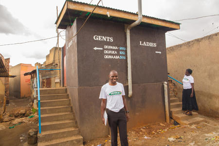 tumwine-christopher-31-a-member-of-the-kamwokya-community-action-team-on-wash-inspecting-a-toilet-that-has-been-recently-constructed-by-a-landlord-during-a-house-to-house-wash-monitoring-exercise-