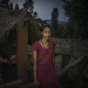 Radha Bishwa Karma, 16, standing outside the chhaupadi hut at night. 