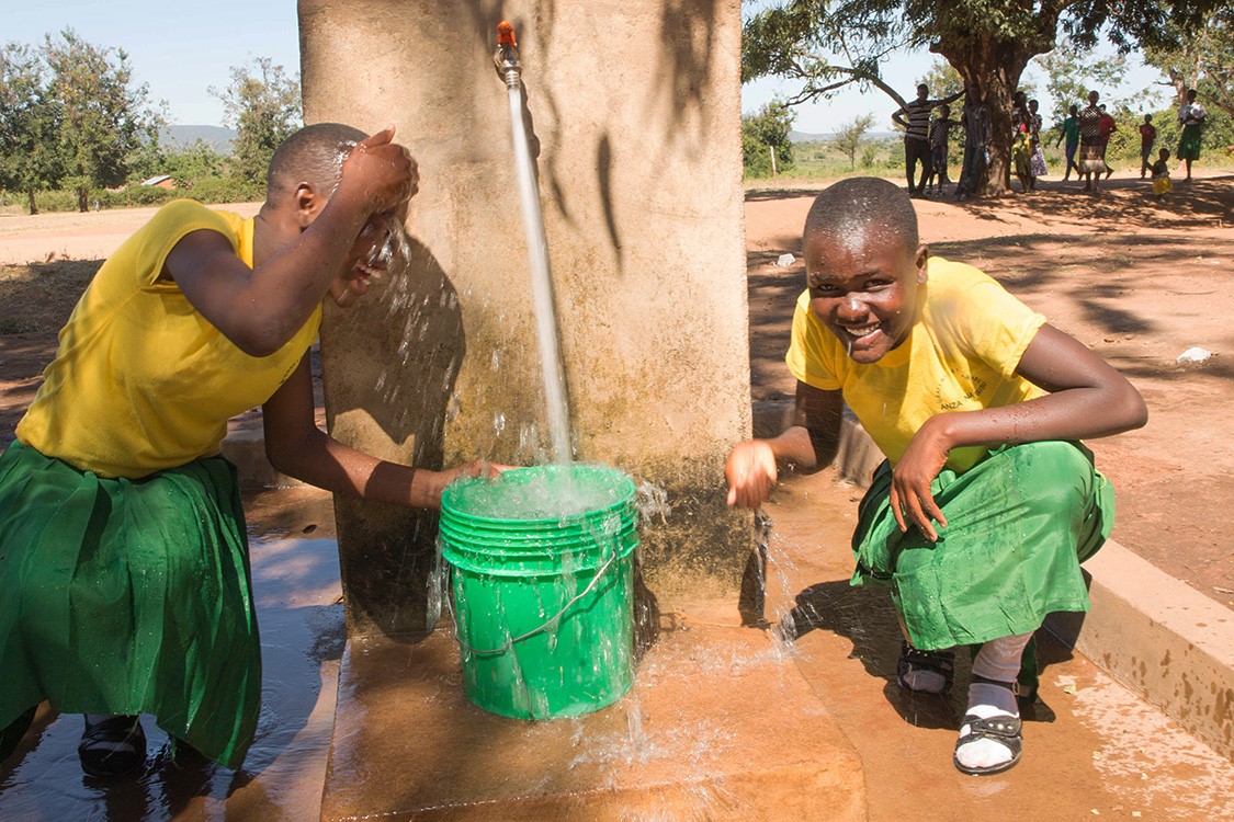 Girls at newly installed public water tapes in Kakora, Tanzania, June 2018