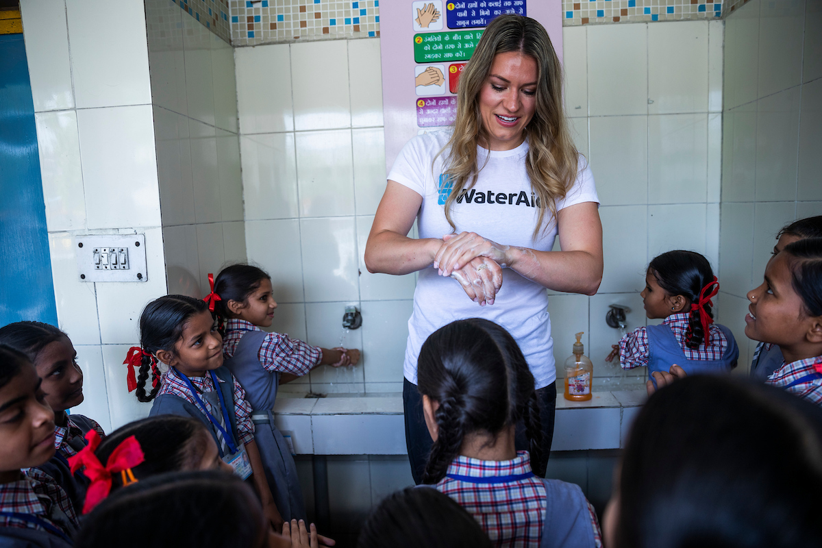 Student's showing Natalie how to practice proper hand washing. 