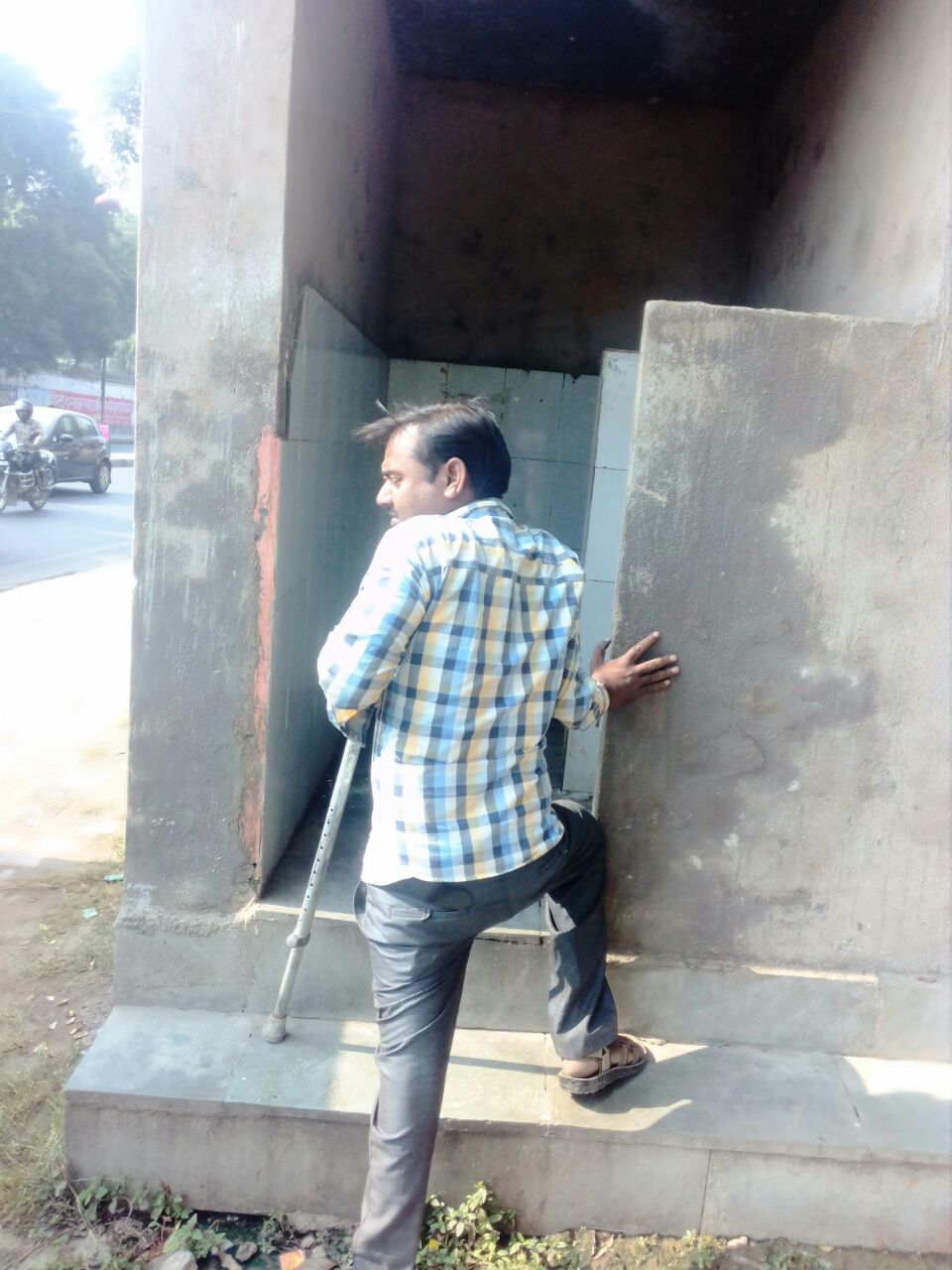 Akhilesh struggles hard to balance his crutches on tiles as well as steps in order to access a public toilet in Daliganj, an area in the heart of Lucknow, the state capital of Uttar Pradesh.