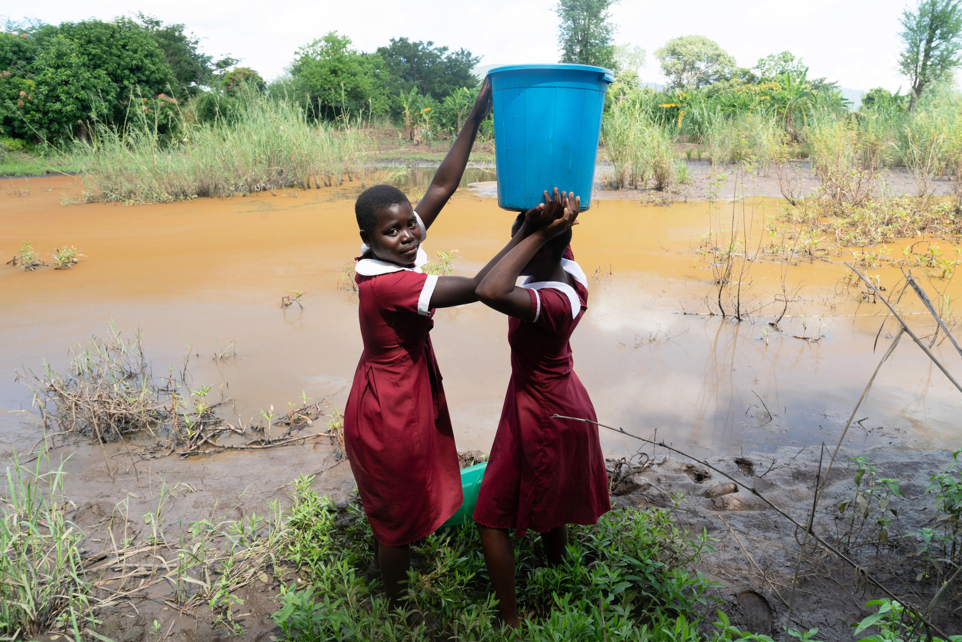 Grace, 16, student, and her friend Ivy, 15, collecting water from a stream, Malawi, April 2022.