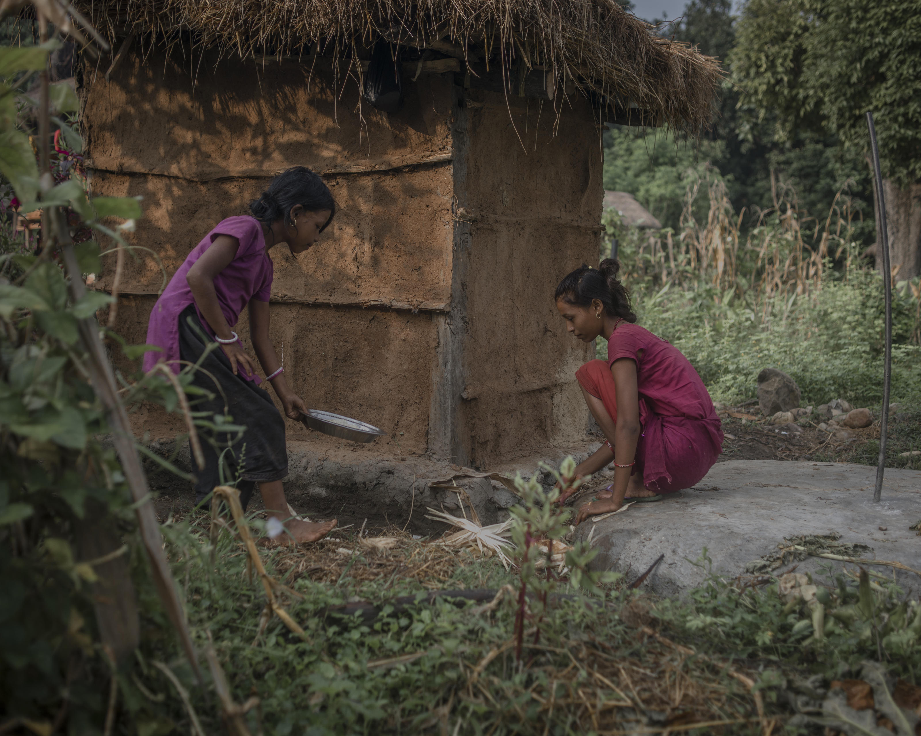 Radha Bishwa Karma, 16, behind the toilet where she is served food (boiled rice only) during chaupadi, Surkhet district, Nepal, 2013.