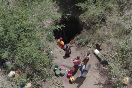 Women in a queue in a  10 feet hand-dug well waiting for water 