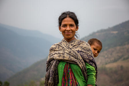 Mandari Bitalu, 22, carrying her daughter Sarita Bitalu, 2, in Dhime, Jajarkot, Nepal, May 2017.
