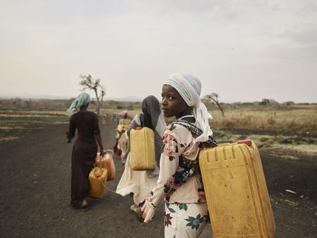 Ansha (12) carrying water from the River Lah in Frat, Ethiopia. February 2020
