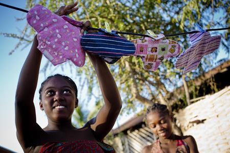 Julianna, 16, hangs up her cotton sanitary towels to dry after washing them, these are given to young girls and women in the community as part of a hygiene awareness project in Morondavo, Madagascar, April 2016