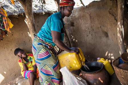 Sedgaa , 40, brews beer from sorghum at her home in Burkina Faso.